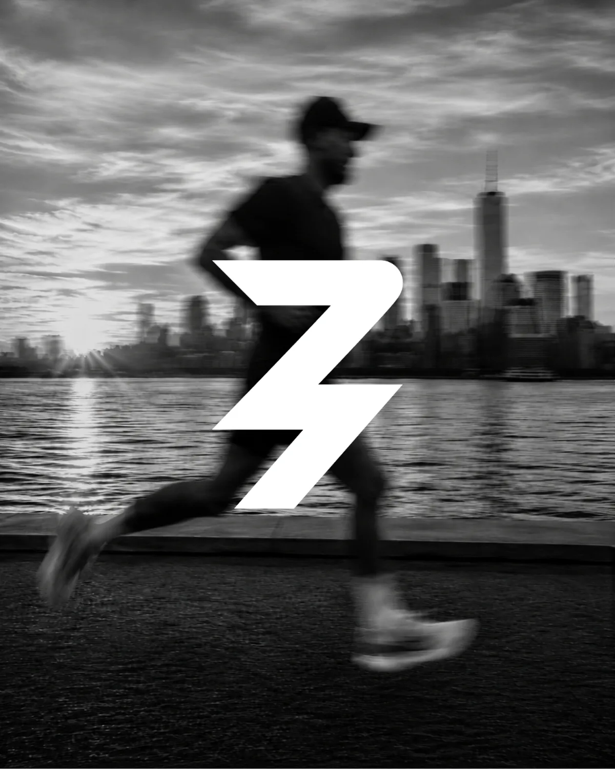 A runner mid-session along the waterfront at dawn, the ZELYTE Strike mark overlaid.